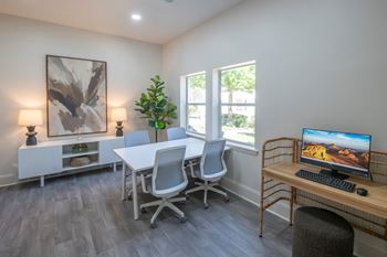 Business center with meeting table and workstation